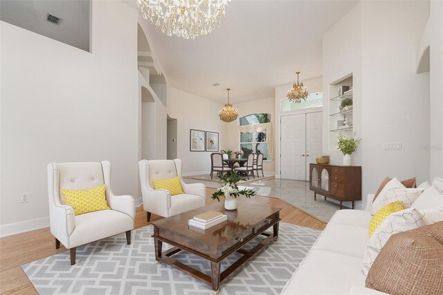 6121 Oxbow Bend Ln, Port Orange, FL 32128 - living area with a chandelier, arched walkways, and light wood-style floors