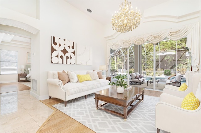6121 Oxbow Bend Ln, Port Orange, FL 32128 - living room featuring a chandelier, plenty of natural light, marble finish flooring, and baseboards