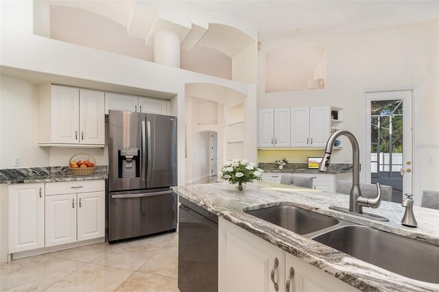 6121 Oxbow Bend Ln, Port Orange, FL 32128 - kitchen featuring stainless steel refrigerator with ice dispenser, a sink, dishwashing machine, white cabinets, and light stone countertops