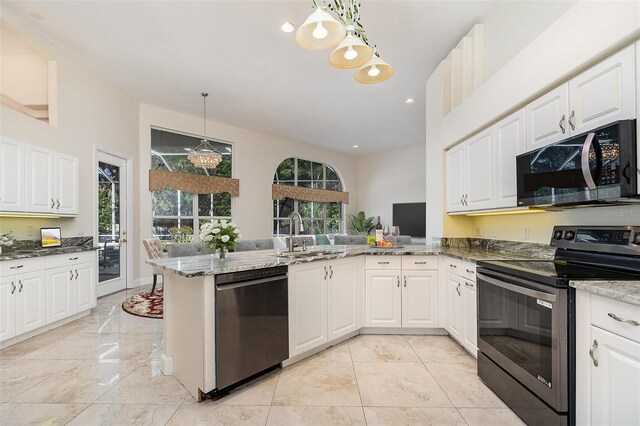 6121 Oxbow Bend Ln, Port Orange, FL 32128 - kitchen featuring stainless steel electric range, dishwasher, a sink, dark stone countertops, and white cabinetry