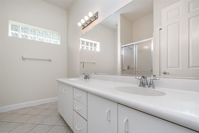 6121 Oxbow Bend Ln, Port Orange, FL 32128 - bathroom featuring double vanity, tile patterned flooring, a shower stall, and baseboards