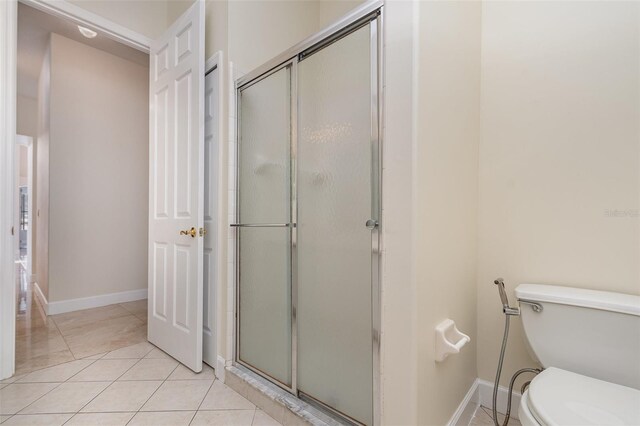 6121 Oxbow Bend Ln, Port Orange, FL 32128 - bathroom with a stall shower, toilet, baseboards, and tile patterned flooring