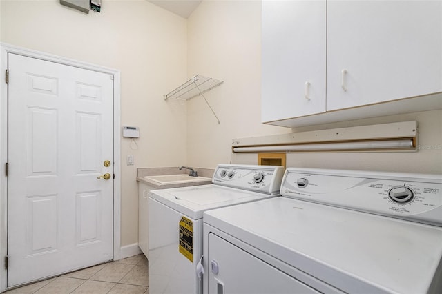 6121 Oxbow Bend Ln, Port Orange, FL 32128 - laundry area featuring washing machine and clothes dryer, light tile patterned floors, cabinet space, and baseboards