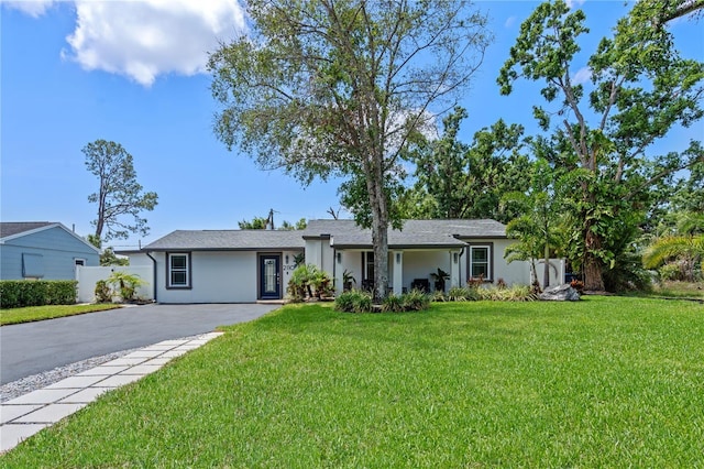 2110 W Farwell Dr, Tampa, FL 33603 - view of front of property featuring stucco siding and asphalt driveway