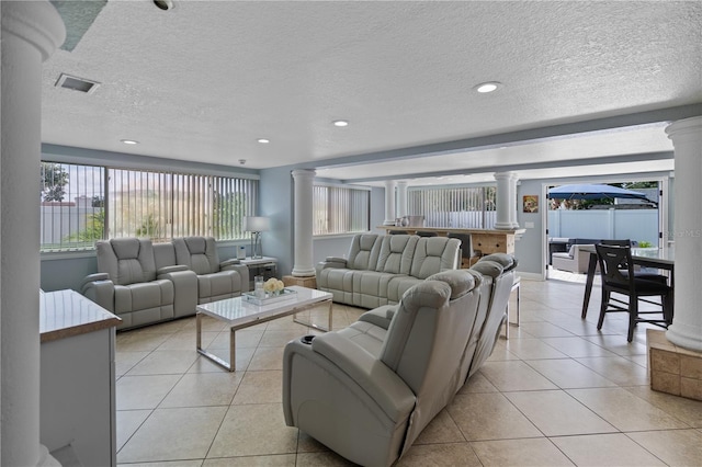 2110 W Farwell Dr, Tampa, FL 33603 - living room with ornate columns, light tile patterned floors, a textured ceiling, and recessed lighting