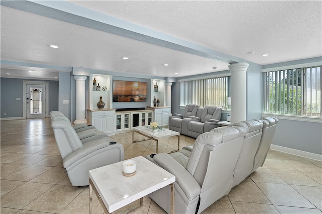 2110 W Farwell Dr, Tampa, FL 33603 - living area with decorative columns, light tile patterned flooring, baseboards, a textured ceiling, and recessed lighting