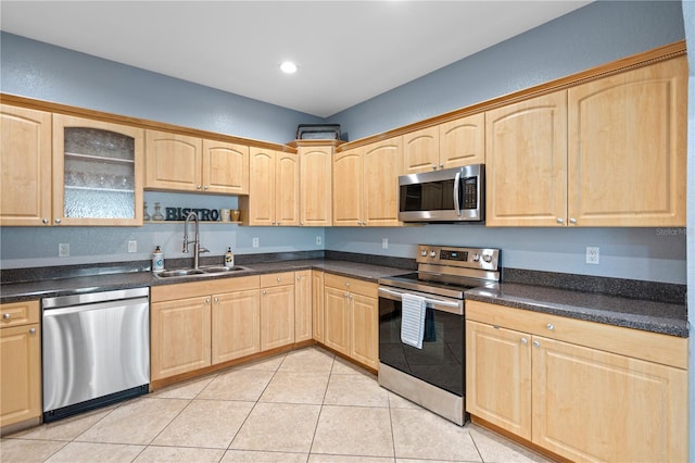 2110 W Farwell Dr, Tampa, FL 33603 - kitchen with stainless steel appliances, a sink, light brown cabinetry, glass insert cabinets, and dark countertops