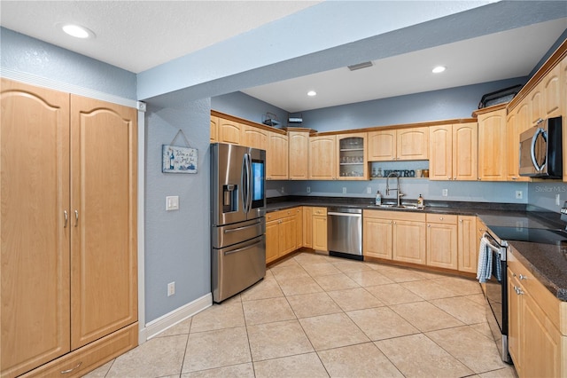 2110 W Farwell Dr, Tampa, FL 33603 - kitchen with stainless steel appliances, a sink, light brown cabinetry, recessed lighting, and light tile patterned flooring