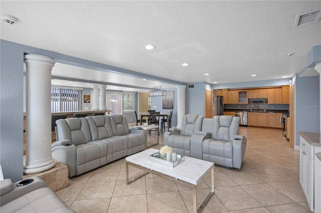 2110 W Farwell Dr, Tampa, FL 33603 - living area with decorative columns, light tile patterned floors, recessed lighting, and a textured ceiling