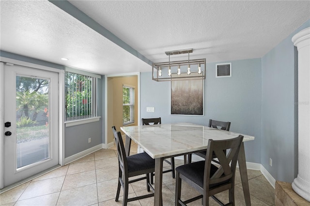 2110 W Farwell Dr, Tampa, FL 33603 - dining room with a textured ceiling, light tile patterned floors, and baseboards