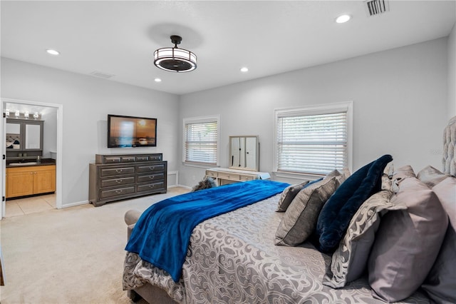 2110 W Farwell Dr, Tampa, FL 33603 - bedroom with recessed lighting, light colored carpet, ensuite bathroom, and baseboards
