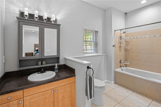 2110 W Farwell Dr, Tampa, FL 33603 - bathroom featuring tiled shower / bath combo, toilet, vanity, and tile patterned floors