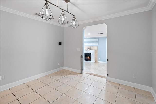 2110 W Farwell Dr, Tampa, FL 33603 - unfurnished room with light tile patterned floors, ornamental molding, baseboards, and a lit fireplace