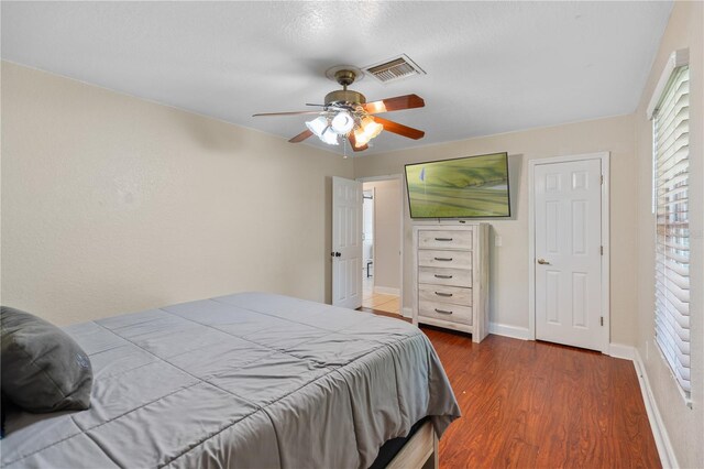 2110 W Farwell Dr, Tampa, FL 33603 - bedroom with wood finished floors, baseboards, and ceiling fan