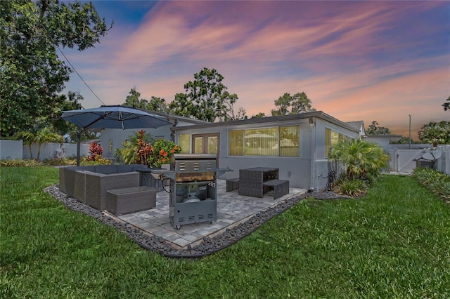 2110 W Farwell Dr, Tampa, FL 33603 - back of property featuring an outdoor hangout area, a patio area, and stucco siding