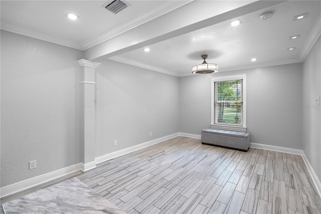 2110 W Farwell Dr, Tampa, FL 33603 - empty room with light wood-type flooring, ornamental molding, a smoke detector, ornate columns, and baseboards