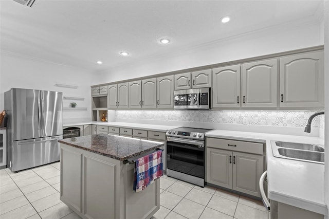 103 Odin Dr, Winter Haven, FL 33884 - kitchen with appliances with stainless steel finishes, gray cabinetry, a sink, open shelves, and crown molding