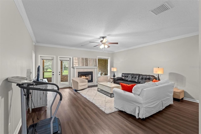 103 Odin Dr, Winter Haven, FL 33884 - living room featuring wood finished floors, a textured ceiling, a ceiling fan, ornamental molding, and baseboards