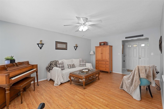 217 Spencer St, Orlando, FL 32839 - living area featuring a ceiling fan, light wood-type flooring, and baseboards