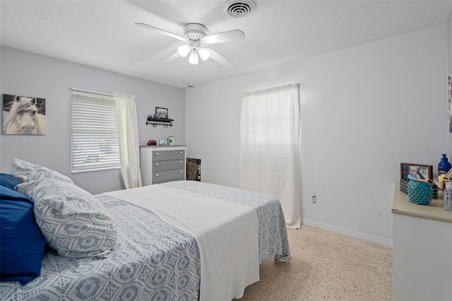 217 Spencer St, Orlando, FL 32839 - bedroom with speckle patterned floor, multiple windows, baseboards, and ceiling fan