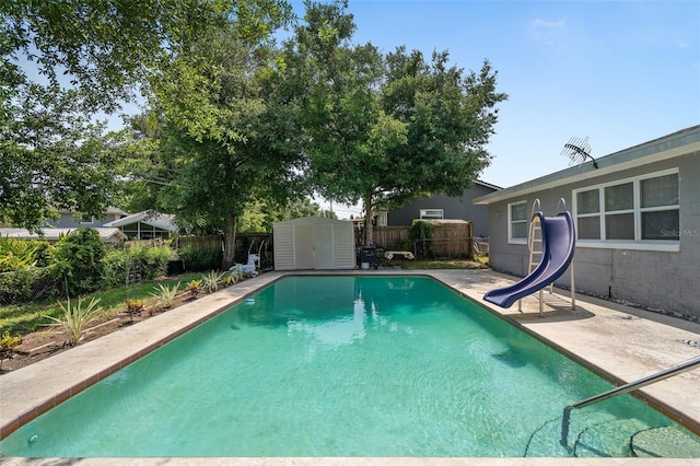 217 Spencer St, Orlando, FL 32839 - view of swimming pool featuring a water slide, a fenced backyard, and a patio area