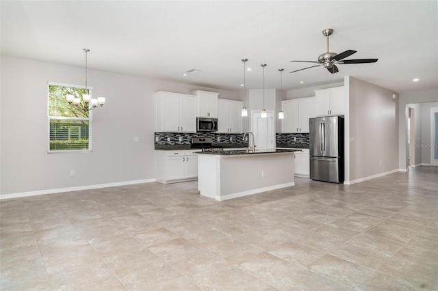 7308 Hermes Ct, Apollo Beach, FL 33572 - kitchen with appliances with stainless steel finishes, open floor plan, dark countertops, backsplash, and recessed lighting