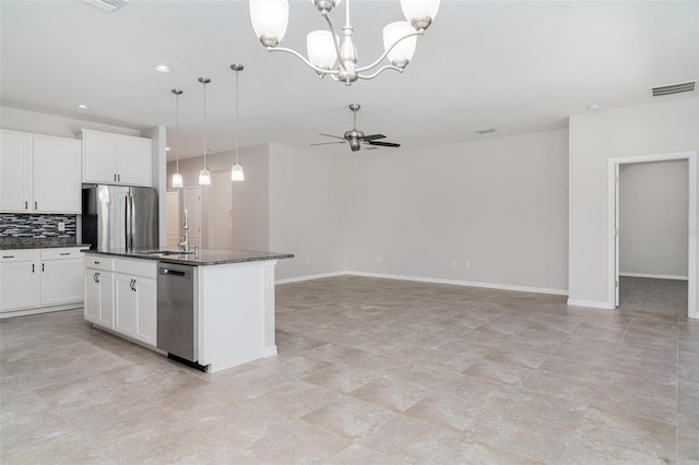 7308 Hermes Ct, Apollo Beach, FL 33572 - kitchen featuring stainless steel appliances, a sink, decorative backsplash, ceiling fan, and baseboards