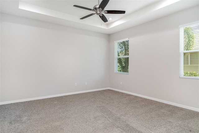 7308 Hermes Ct, Apollo Beach, FL 33572 - unfurnished room with a tray ceiling, carpet floors, ceiling fan, baseboards, and recessed lighting