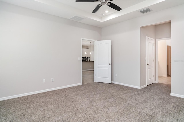 7308 Hermes Ct, Apollo Beach, FL 33572 - unfurnished bedroom featuring carpet floors, baseboards, recessed lighting, a ceiling fan, and a tray ceiling