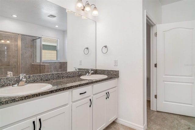 7308 Hermes Ct, Apollo Beach, FL 33572 - full bath featuring double vanity, a tile shower, baseboards, and tile patterned floors