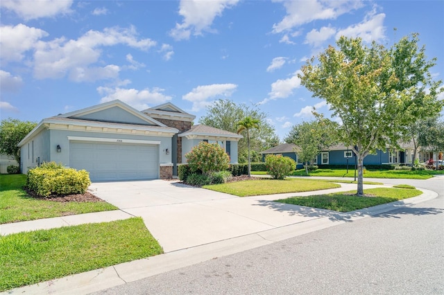 7308 Hermes Ct, Apollo Beach, FL 33572 - view of front facade with driveway, a front yard, a garage, and stone siding
