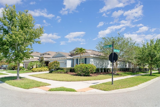 7308 Hermes Ct, Apollo Beach, FL 33572 - view of front of house featuring a front lawn and stucco siding