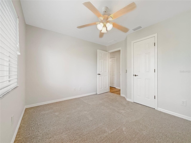 13210 Essman Ave, Port Charlotte, FL 33953 - unfurnished bedroom with carpet floors, baseboards, and a ceiling fan