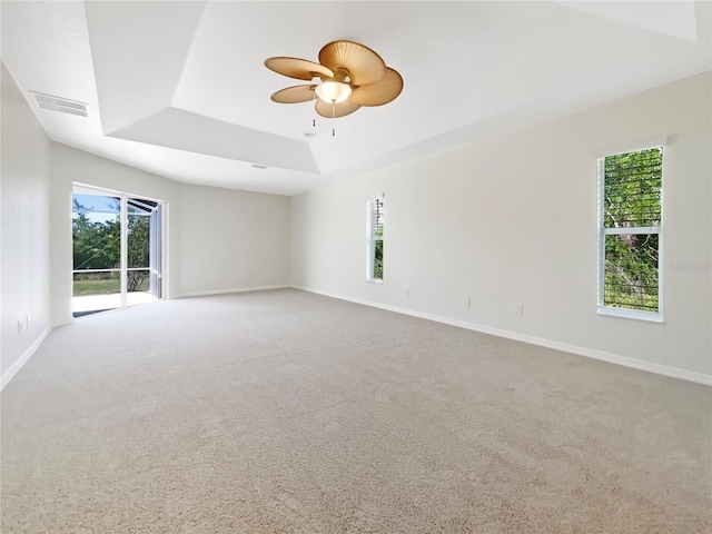 13210 Essman Ave, Port Charlotte, FL 33953 - unfurnished room with a raised ceiling, plenty of natural light, a ceiling fan, and carpet floors