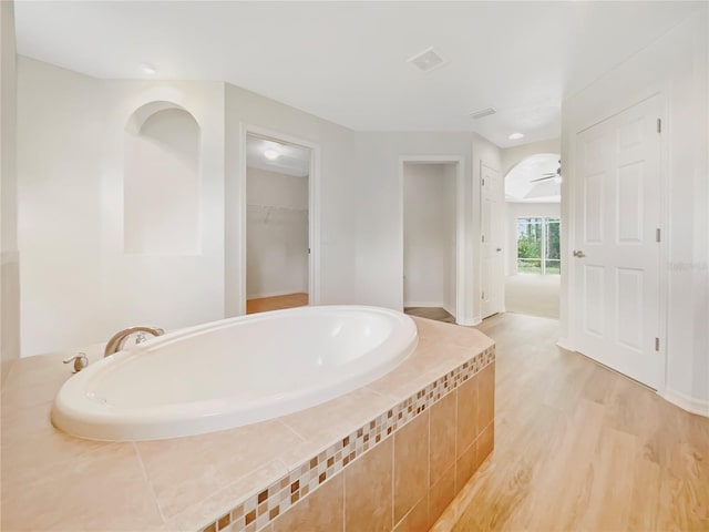 13210 Essman Ave, Port Charlotte, FL 33953 - full bathroom featuring a bath, wood finished floors, a spacious closet, and ceiling fan
