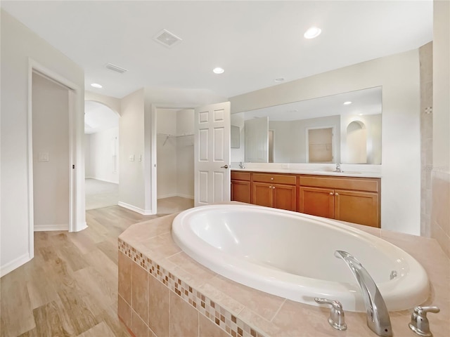 13210 Essman Ave, Port Charlotte, FL 33953 - bathroom with a garden tub, double vanity, wood finished floors, recessed lighting, and a spacious closet