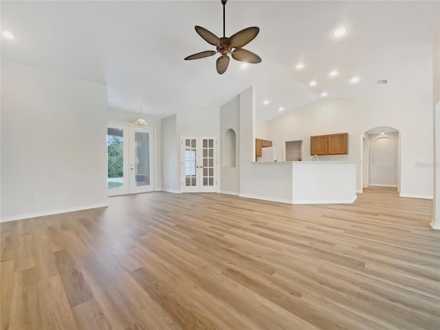 13210 Essman Ave, Port Charlotte, FL 33953 - unfurnished living room featuring arched walkways, a ceiling fan, light wood-style flooring, baseboards, and recessed lighting