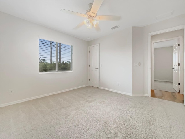 13210 Essman Ave, Port Charlotte, FL 33953 - unfurnished bedroom featuring carpet, baseboards, and a ceiling fan