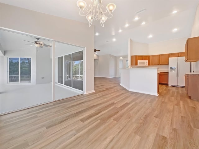 13210 Essman Ave, Port Charlotte, FL 33953 - unfurnished living room featuring a ceiling fan, light wood finished floors, a chandelier, baseboards, and high vaulted ceiling