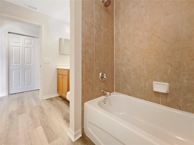 13210 Essman Ave, Port Charlotte, FL 33953 - bathroom featuring vanity, wood finished floors, shower / bathtub combination, toilet, and baseboards