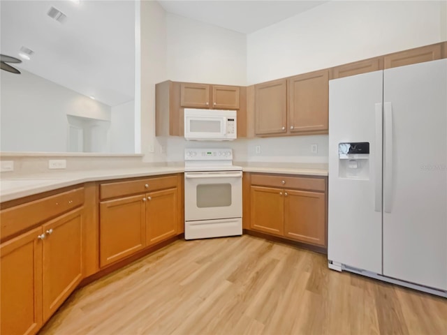13210 Essman Ave, Port Charlotte, FL 33953 - kitchen featuring white appliances, light wood finished floors, light countertops, and vaulted ceiling