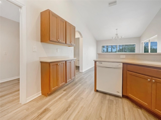 13210 Essman Ave, Port Charlotte, FL 33953 - kitchen featuring white dishwasher, arched walkways, light wood-style floors, light countertops, and vaulted ceiling