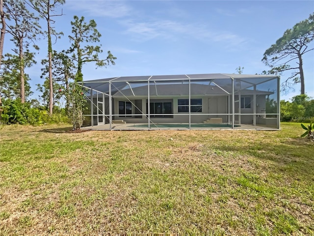 13210 Essman Ave, Port Charlotte, FL 33953 - back of house with a lawn, an outdoor pool, and a lanai