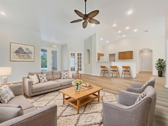 13210 Essman Ave, Port Charlotte, FL 33953 - living room featuring arched walkways, a ceiling fan, light wood-style floors, french doors, and baseboards