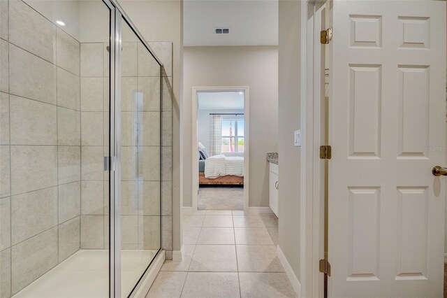 1323 Normandy Dr, Haines City, FL 33844 - bathroom with a shower stall, baseboards, tile patterned floors, and connected bathroom