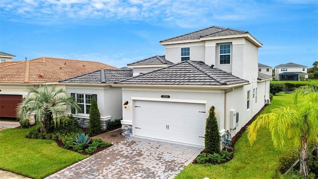 32740 Tree Of Life Ave, Wesley Chapel, FL 33543 - traditional-style house featuring an attached garage, stucco siding, decorative driveway, and a front yard