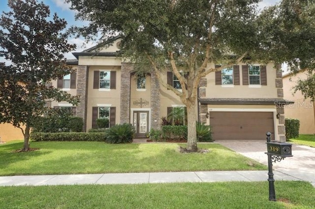 319 Morning View Dr, Winter Garden, FL 34787 - view of front of house with driveway, a garage, a front lawn, and stucco siding