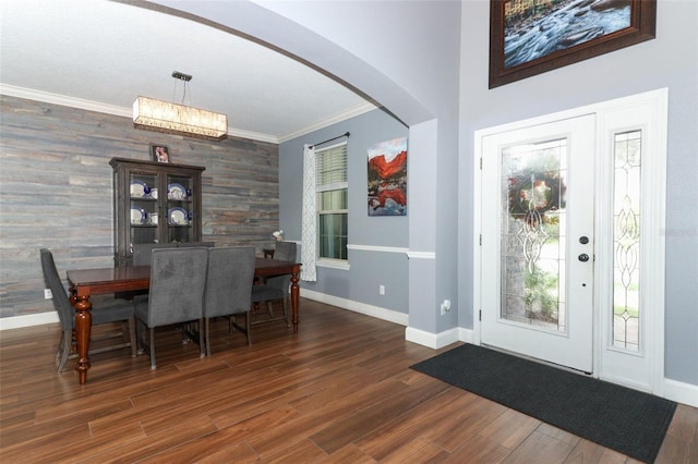 319 Morning View Dr, Winter Garden, FL 34787 - dining room with crown molding, wood finished floors, arched walkways, plenty of natural light, and an accent wall