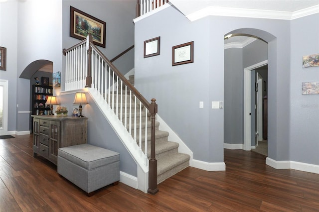319 Morning View Dr, Winter Garden, FL 34787 - stairs featuring arched walkways, wood finished floors, and crown molding