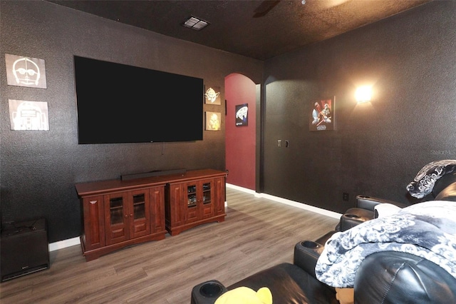 319 Morning View Dr, Winter Garden, FL 34787 - home theater with light wood-type flooring, arched walkways, and a ceiling fan